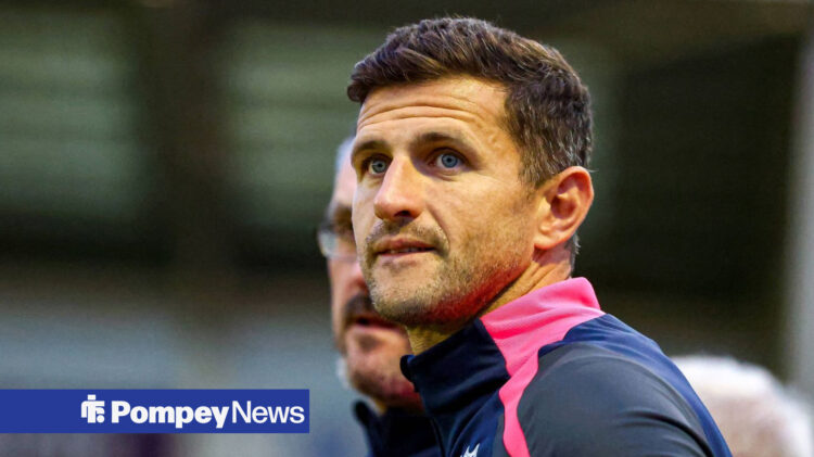 Portsmouth manager John Mousinho stares into the distance.