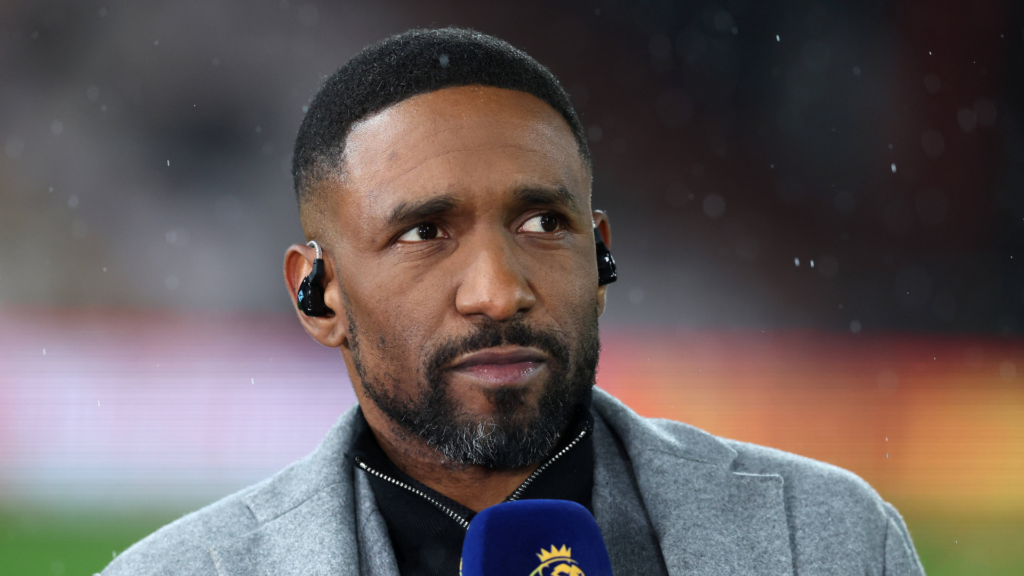 Jermaine Defore in a suit with a microphone