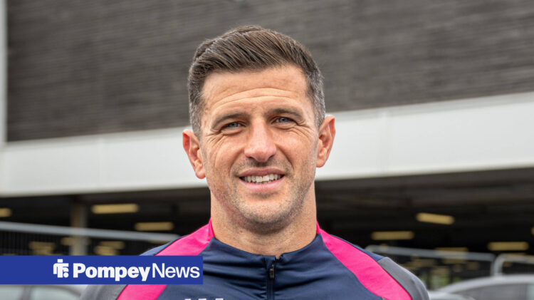 Portsmouth boss John Mousinho smiling.