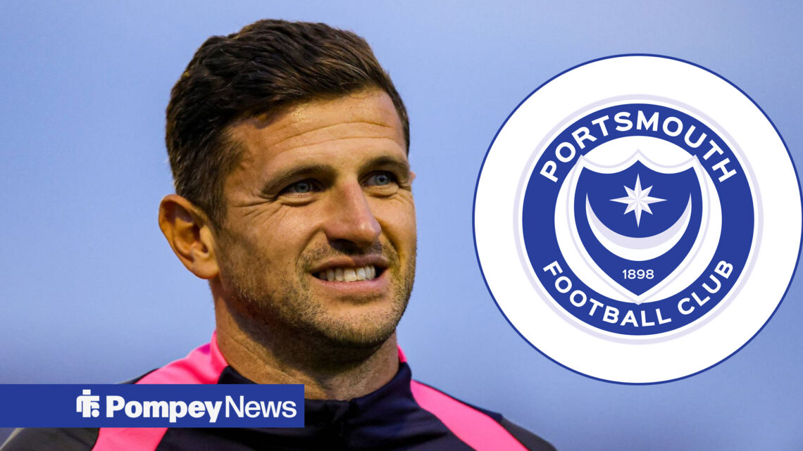 John Mousinho looking happy, with Portsmouth badge in circular frame