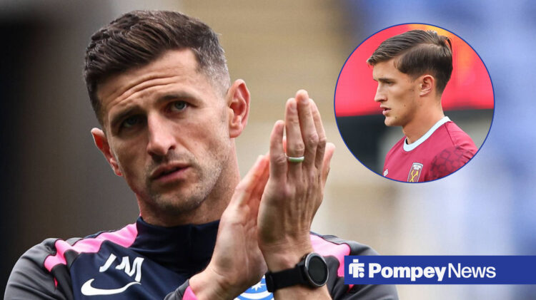 Portsmouth manager John Mousinho clapping while looking at Freddie Potts wearing a West Ham shirt