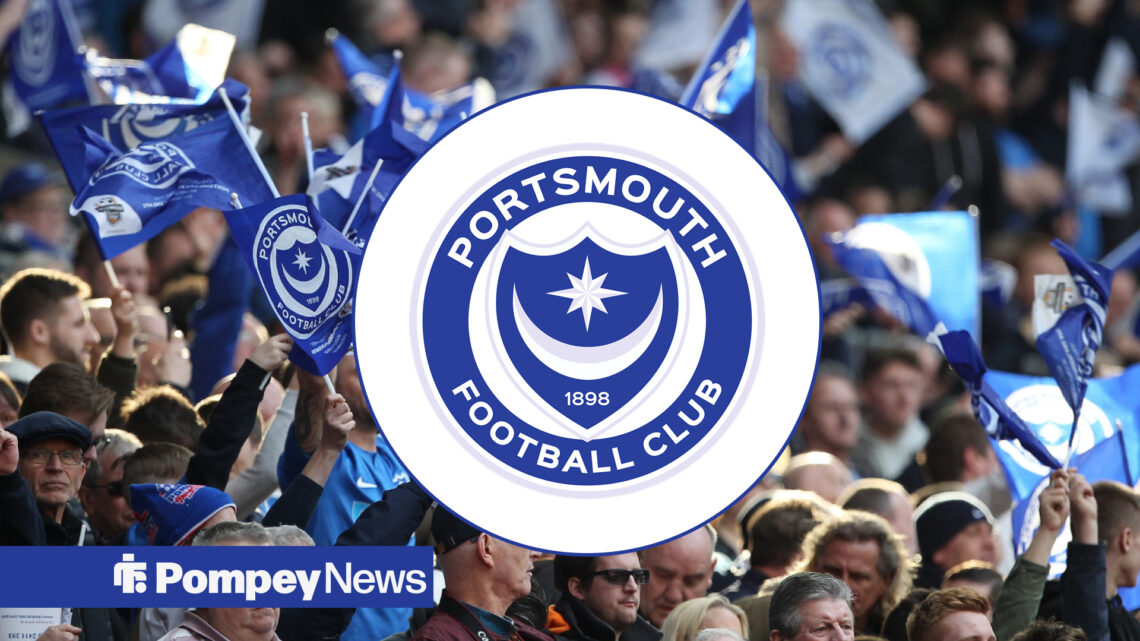 Portsmouth fans with blue Portsmouth flags and Portsmouth crest