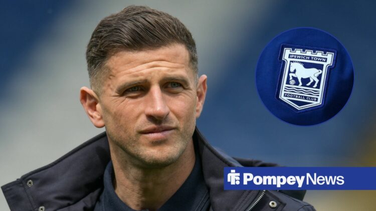 John Mousinho looks at Ipswich Town badge in circle