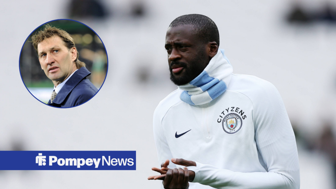 Yaya Toure warming up at Manchester City looking towards Tony Adams in circle