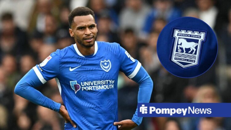Josh Murphy looking at Ipswich badge in circle