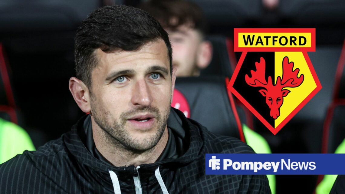 John Mousinho looking at Watford badge on right