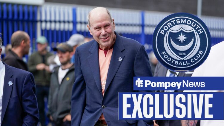 Michael Eisner looking at Portsmouth badge in circle