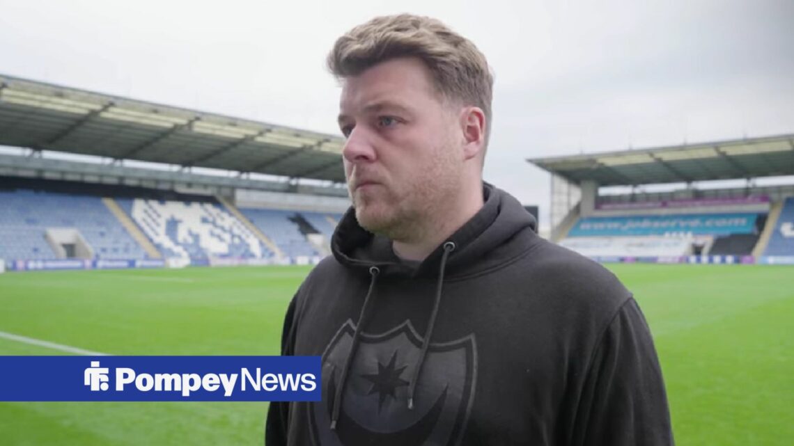 Jay Sadler in black Portsmouth hoodie conducting post match interview