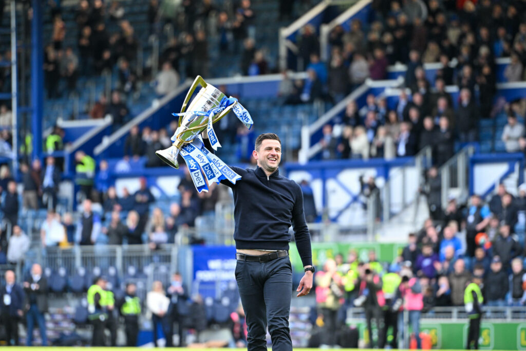 John Mousinho lifting the League One trophy